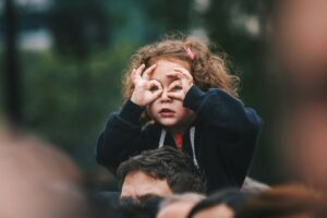 A little girl trying to see something