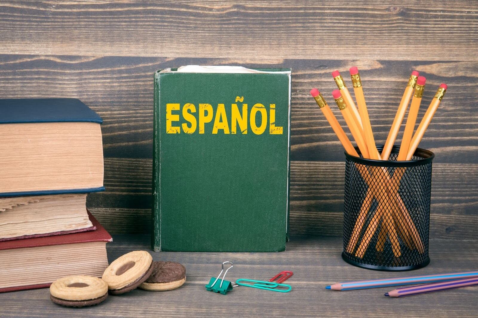 A spanish textbook surrounded by other school items