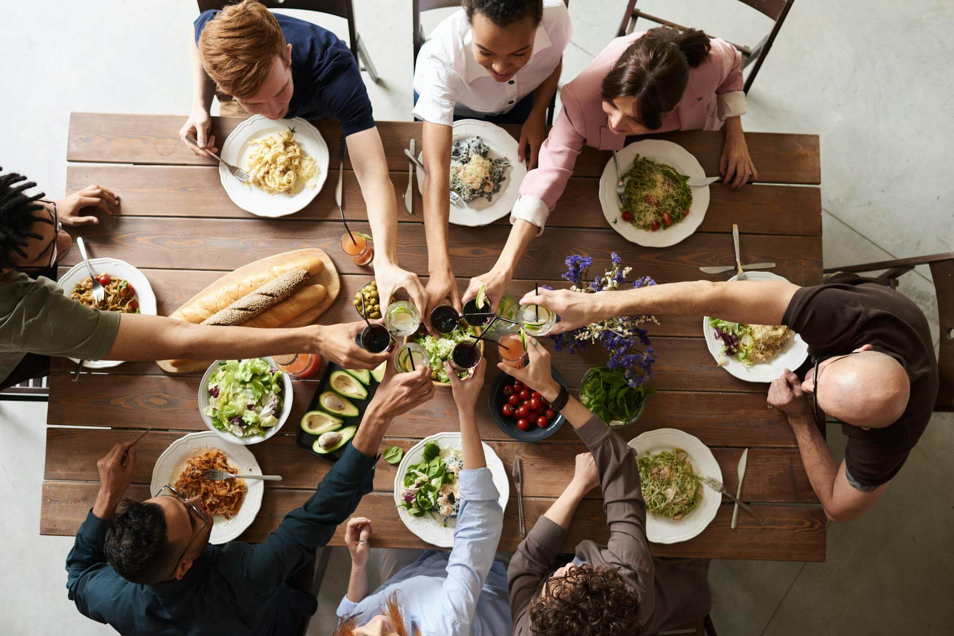 A group of people eating dinner together and making a toast